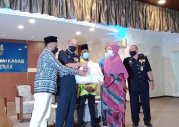 MIOR Faridalathrash Wahid (dua dari kiri) menyantuni salah seorang penerima sumbangan di Mes Pegawai Kanan Polis di Ipoh.