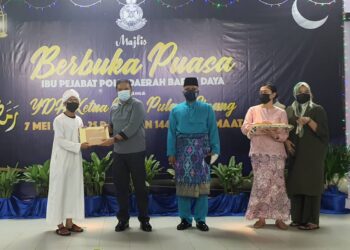 SAHABUDIN Abd. Manan menyerahkan sumbangan kepada pelajar tahfiz pada Majlis Berbuka Puasa Ibu Pejabat Polis Daerah Barat Daya, Pulau Pinang malam tadi.