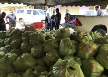 PETUGAS selesai membungkus bantuan makanan yang mula diagihkan kepada Orang Asli di sekitar Gua Musang, Kelantan hari ini. UTUSAN/AIMUNI TUAN LAH