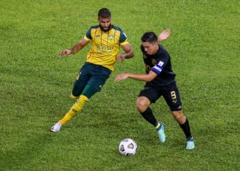 PEMAIN Kedah, Anumanthan Mohan Kumar (kiri) cuba mematahkan serangan kapten Perak, Sergio Fabian Ezequiel Aguaero dalam perlawanan Liga Super di Stadium Darul Aman, malam kelmarin.- UTUSAN/SHAHIR NOORDIN