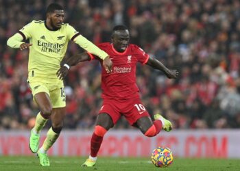 PEMAIN tengah Arsenal, Ainsley Maitland-Niles (kiri) cuba menghalang percubaan penyerang Liverpool, Sadio Mane dalam aksi Liga Perdana Inggeris di Anfield, semalam.- AFP