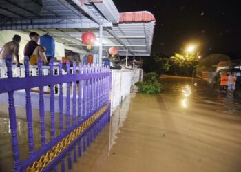 PENDUDUK Taman Indah Jaya, Lukut, Port Dickson menyelamatkan diri dan harta benda mereka selepas rumah mereka dinaiki air dalam kejadian banjir selepas hujan lebat, awal pagi tadi.-UTUSAN/MOHD. SHAHJEHAN MAAMIN.