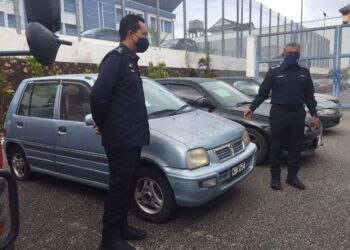 RAMLI Mohamed Yoosuf (kanan) menunjukkan kereta yang merupakan barang kes hasil tangkapan sindiket curi kereta Geng Abu Pandan di Stor Barang Kes Berpusat, Indera Mahkota di Kuantan, Pahang. - UTUSAN/ DIANA SURYA ABD WAHAB