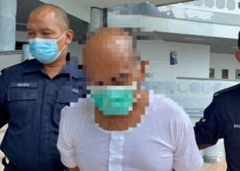 TERTUDUH diiring keluar anggota polis selepas Mahkamah Sesyen, Ayer Keroh, Melaka menjatuhkan hukuman penjara 14 tahun dan empat sebatan atas kesalahan melakukan amang seksual fizikal terhadap anak kandung. - UTUSAN/DIYANATUL ATIQAH ZAKARYA