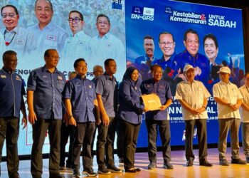 BUNG Moktar Radin (empat kanan) menyampaikan watikah pelantikan kepada calon Lahad Datu, Maizatul Akmam Alawi (lima kiri) di Kota Kinabalu hari ini.