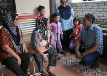 KHAIRY Jamaluddin beramah mesra dengan penduduk Sungai Buloh pada sesi walkabout di Paya Jaras Hilir, di sini, hari ini. -UTUSAN/HAFIZI SAID