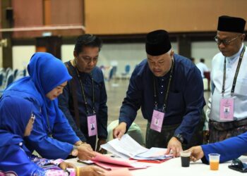 ROZABIL Abd. Rahman (dua dari kanan) memeriksa borang pencalonan semasa proses penamaan calon Parlimen Arau di Politeknik Tuanku Syed Sirajuddin, Arau, Perlis hari ini.- UTUSAN/IZLIZAN OTHMAN