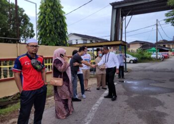 TAKIYUDDIN Hassan (kanan) beramah mesra dengan pengundi yang keluar untuk menjalankan tanggungjawab di Maktab Sultan Ismail, Kota Bharu, Kelantan hari ini. - UTUSAN/MUSTAQIM MOHAMED