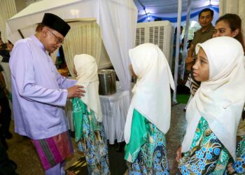 ANWAR Ibrahim beramah mesra dengan anak-anak yatim pada majlis berbuka puasa warga pendidik, ilmuan, ulama dan NGO Islam di Kompleks Seri Perdana, Putrajaya. - UTUSAN/FAISOL MUSTAFA