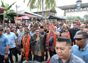 ANWAR Ibrahim diiringi Hajiji Noor semasa tiba di pekarangan Dewan Hongkod Koisaan KDCA di Penampang, Sabah, hari ini.