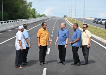 FADILLAH Yusof (tiga dari kanan) dan Ahmad Samsuri Mokhtar (tiga dari kiri) meninjau jajaran Jalan Pintas Kuala Terengganu selepas majlis perasmian di Kuala Terengganu, hari ini. - UTUSAN/PUQTRA HAIRRY ROSLI