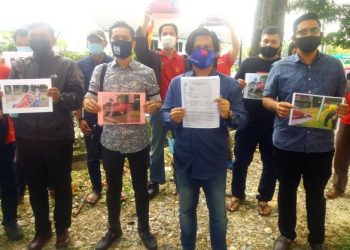 MOHD. Dendera Billah Zamzuri (dua dari kanan) menunjukkan laporan polis berhubung kain rentang yang digantung itu di Balai Polis Seksyen 6, Shah Alam, Selangor hari ini. - FOTO/ISKANDAR SHAH MOHAMED