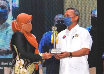 HASNI Mohammad menyampaikan trofi kepada Kelab Terbaik Sahabat Usahawan AIM sempena Majlis Perasmian Bengkel Kepemimpinan Pusat Sahabat Usahawan AIM Wilayah Johor di Hotel Impiana, Senai, Johor. - FOTO/RAJA JAAFAR ALI