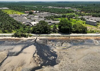 PEMANDANGAN dari udara menunjukkan saliran air berwarna hitam bersebelahan sebuah ladang ternakan babi di Tanjung Sepat, Sepang, Selangor. – UTUSAN/MUHAMAD IQBAL ROSLI