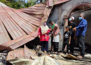 ARDANAN Dollah (kanan) melihat kesan kebakaran di rumah milik Mohamad Masri Mat Isa (dua dari kanan) di Kampung Lubuk Besar, Sik, semalam. – FOTO/ZAID MOHD. NOOR