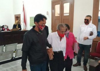 KOSWARA (tengah) semasa hadir ke mahkamah dan ditemani dua anaknya. -KOMPAS.COM