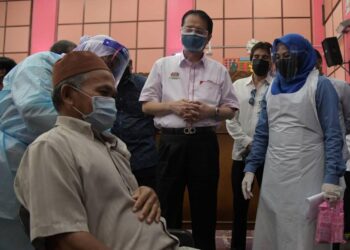 NORAINI Ahmad (kanan) bersama Dr. Noor Hisham Abdullah (tengah) meninjau program rintis PPV Bergerak, Hospital Canselor Tuanku Muhriz (HCTM) di Batu Pahat, Johor, hari ini.