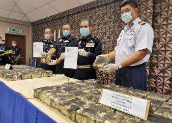 ABDUL MAJID Mohd. Ali (dua dari kanan) menunjukkan surat kebenaran rentas negeri palsu yang digunakan suspek untuk meloloskan diri di SJR. - UTUSAN/DIYANATUL ATIQAH ZAKARYA