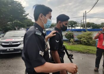 ABDULLAH Sidee Mohamed (kiri) dipimpin rakannya selepas selesai mengundi awal di IPD Kuala Selangor, Kuala Selangor, Selangor. -UTUSAN/ ISKANDAR SHAH MOHAMED