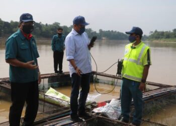 MOHD. Sharkar Shamsudin (tengah)  dan Mohd. Sani Mat Daud (kiri) menguji kualiti air Sungai Pahang di atas sangkar Mohd. Zahir Ibrahim di Kampung Pengkalan Manggis di Temerloh, Pahang 
UTUSAN/SALEHUDIN MAT RASAD