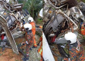 ANGGOTA bomba berusaha mengeluarkan seorang lelaki yang meninggal dunia selepas lori yang dipandunya terbabit nahas dengan sebuah lagi lori dalam kejadian di simpang tiga Jelai menuju ke Bukit Rokan, Tampun hari ini.-GAMBAR/IHSAN BOMBA