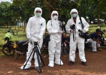 TIGA wartawan AFP memakai sut perlindungan diri (PPE) ketika membuat liputan Covid-19 di tanah perkuburan Pondok Ranggon di Jakarta, Indonesia. - AFP