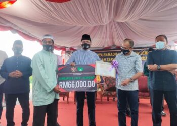 MOHD. Salim Mohd. Sharif (tengah) menyerahkan cek sumbangan zakat korporat Risda berjumlah RM66,000 kepada Pengerusi Masjid Jamek Bahau, Nasarudin Musa pada Program Ihya Ramadan Parlimen Jempol dan Sumbangan Zakat Korporat Serta Dividen Risda di Masjid Jamek Bahau, Jempol semalam.-UTUSAN/NURULAZMA SHAFIQAH KHAIRUL AZHAR